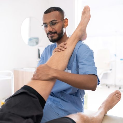 Physiotherapist providing rehabilitation therapy for mobility and pain management.